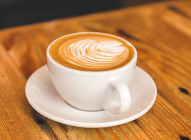 istock Perfect cappuccino in white cup on wood table 642324540