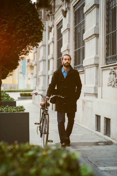 istock Businessman pushing Bicycle In City 642327460