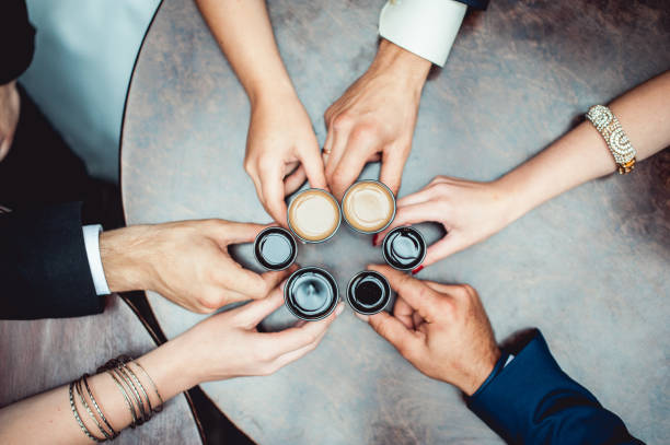 istock friends toasting with a liqueur shots above round table 642327500