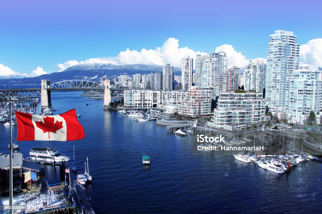 Vancouver Canada Canadian flag in front of view of False Creek and the Burrard street bridge in Vancouver, Canada. Vancouver - Canada Stock Photo