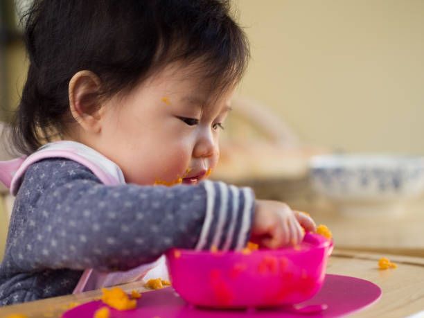 istock eating mess baby girl 642333492