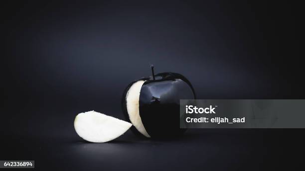 Sliced Black Apple On A Background Stock Photo - Download Image Now - Apple - Fruit, Black Color, Poisonous