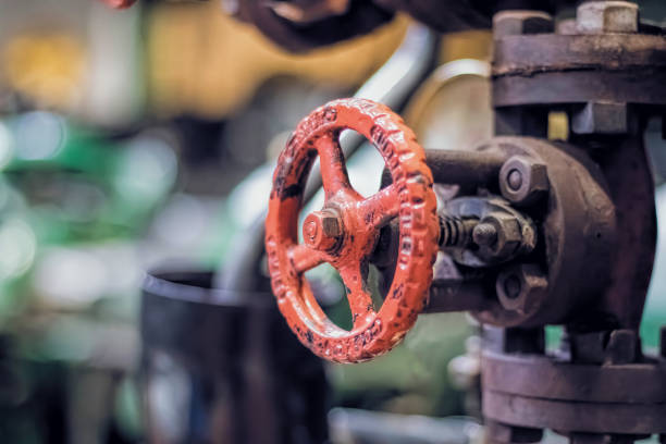 istock Red Valve Wheel and Industrial Pipes 642340902