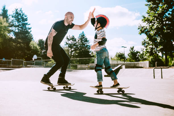 istock Father and Son at Skateboard Park 642360080