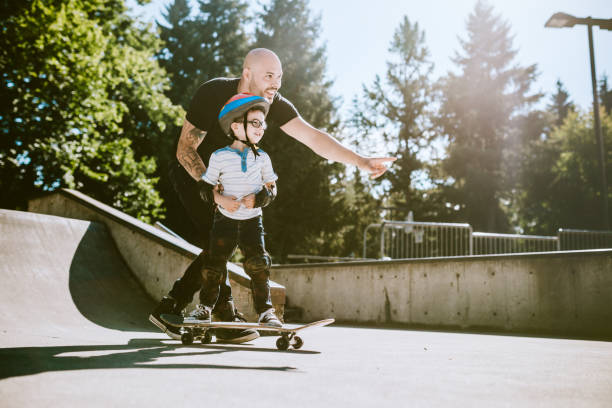 istock Father and Son at Skateboard Park 642360104