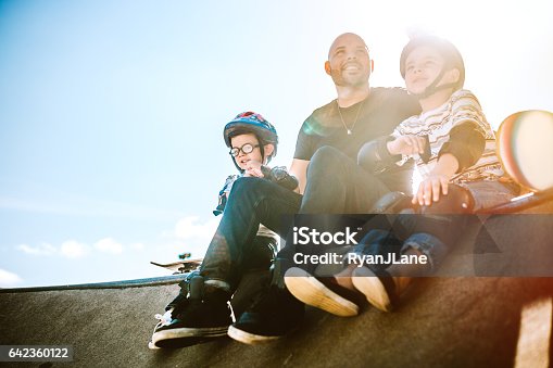 istock Father and Sons Skateboarding 642360122