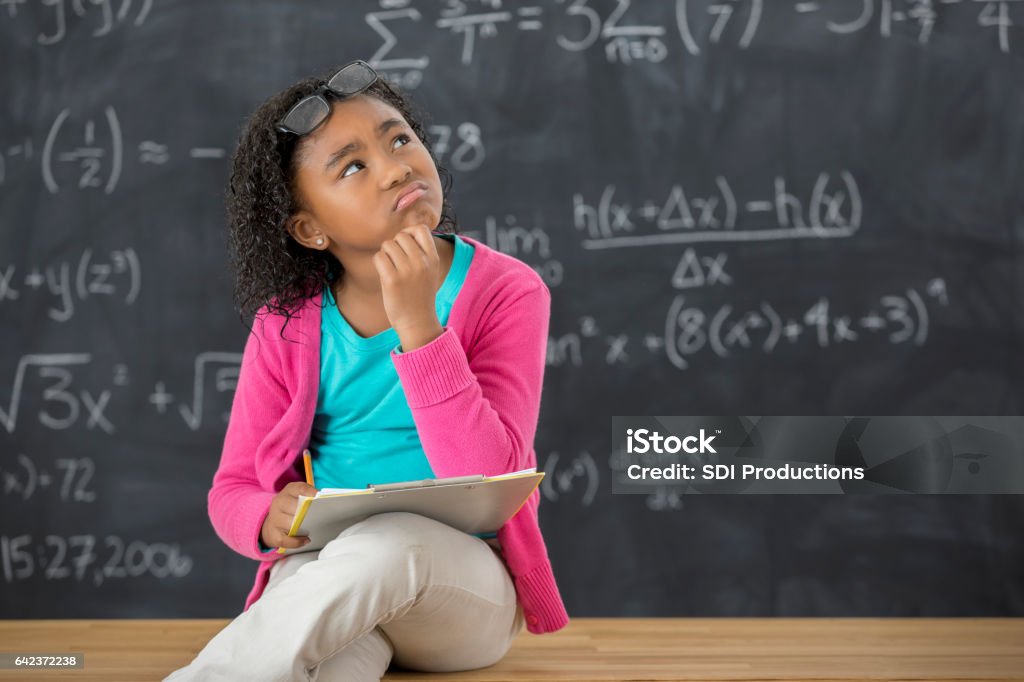 Student Looking At Math Elementary School Student Contemplates Math Problem Stock Photo ...