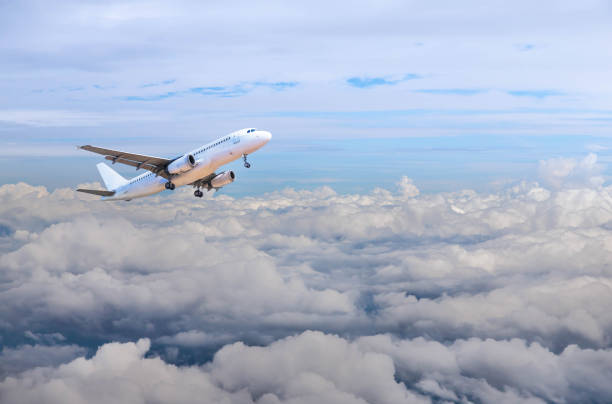 istock airplane flying in to sky above the white clouds 642372380