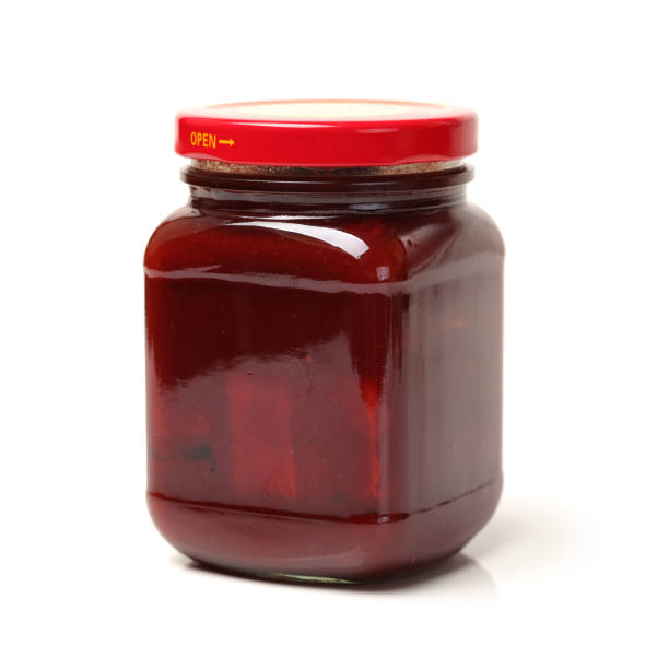 istock Preserved bean curd with chili in glass jar on white background 642376616