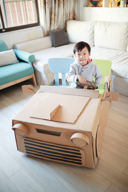 istock Children play in the cardboard car 642388196