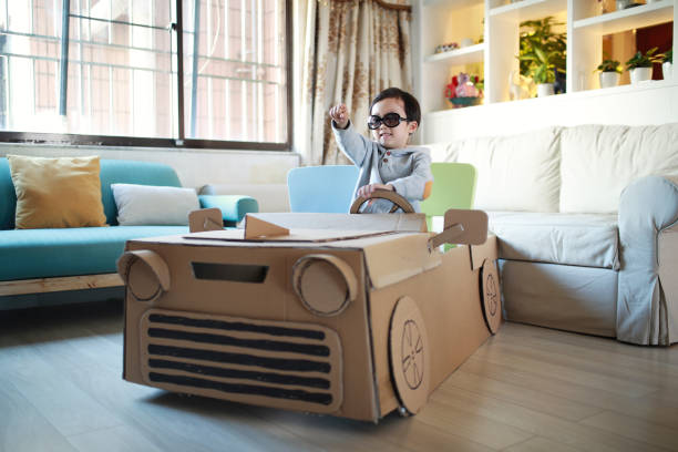 Children play in the cardboard car