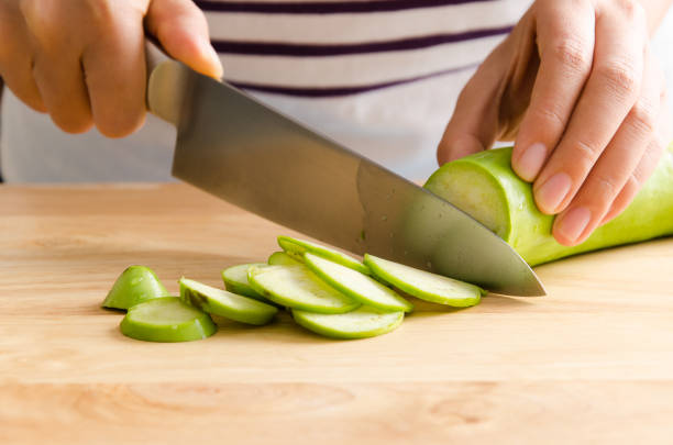 istock Woman chopping green eggplant 642392184