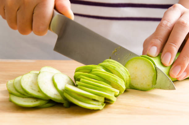 istock Woman chopping green eggplant 642392190
