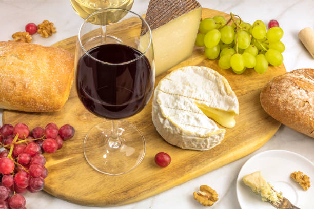 istock Wine and cheese tasting with bread, grapes and glasses 642398090