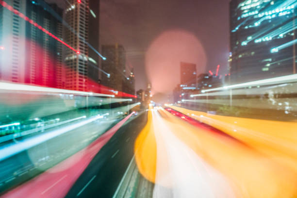istock light trails on city street with cityscape 642402620