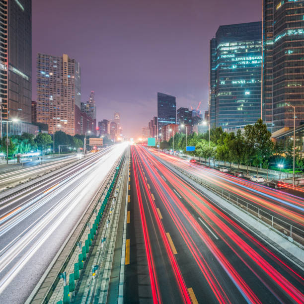 istock light trails on city street with cityscape 642402888