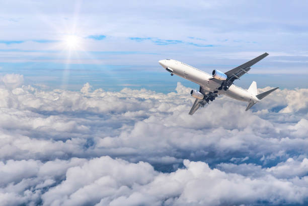 istock airplane flying in to sky high altitude above white clouds 642412058
