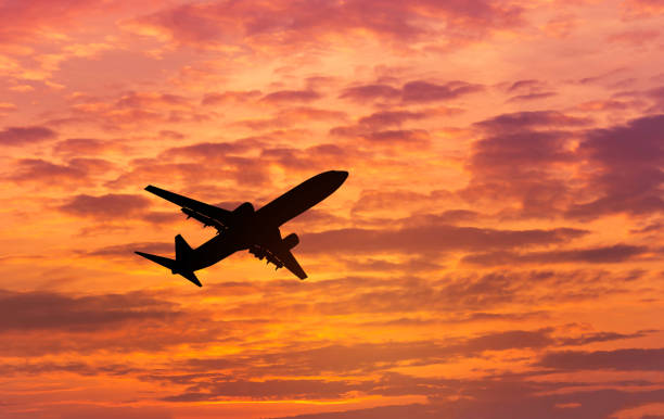 istock Silhouette passenger airplane flying away in to sky on sunset 642424956