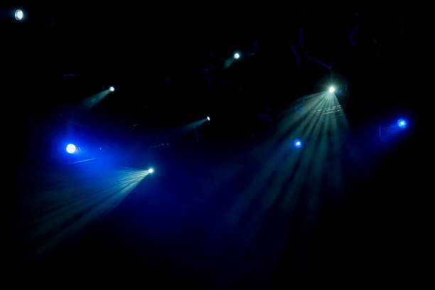 istock Blue rays of light through the smoke on stage. Theater performance. Lighting equipment 642430632
