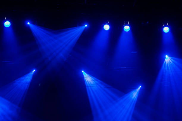 istock Blue rays of light through the smoke on stage. Theater performance. Lighting equipment 642430640