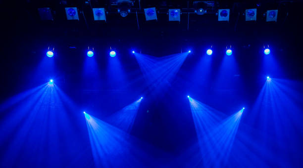 istock Blue rays of light through the smoke on stage. Theater performance. Lighting equipment 642430642