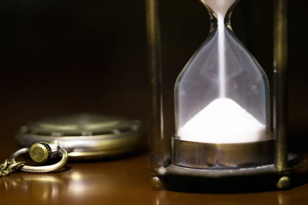 istock Hourglass and vintage pocket watch 642431748
