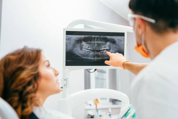 istock Dentist showing a patient her x-ray 642434828
