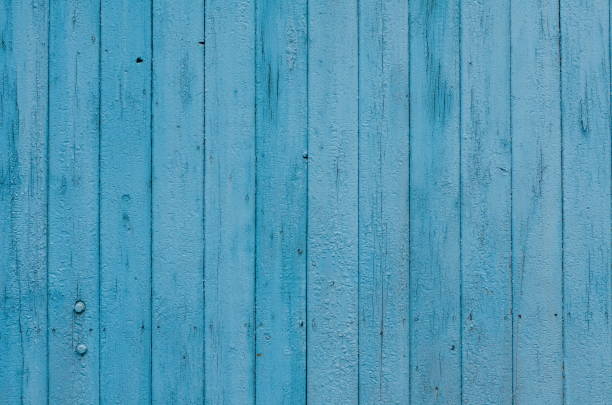 istock Cracked weathered green and blue painted wooden board texture 642438820