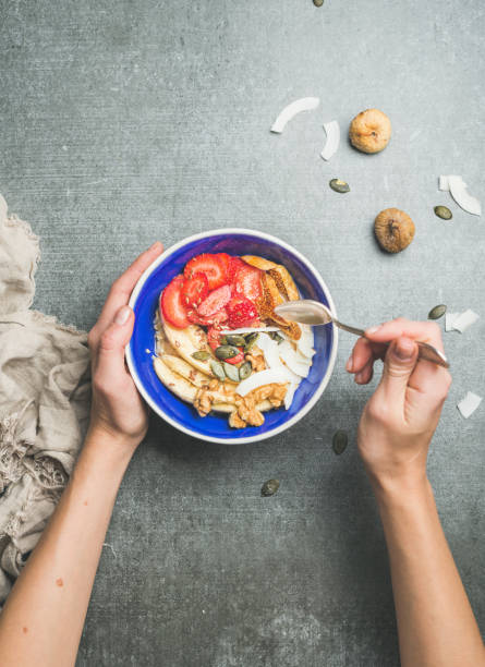istock Woman's hands holding drizzlier and blue healthy breakfast bowl 642441428
