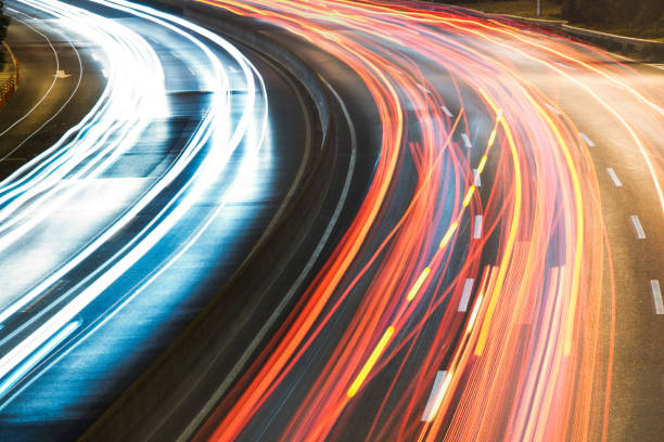 istock light trails on city street with cityscape 642441480