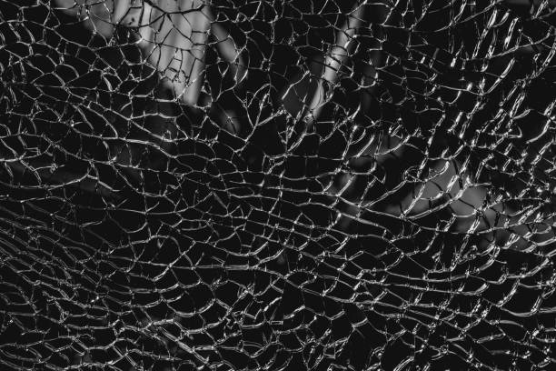istock cracked and broken glass. black and white color background 642441556