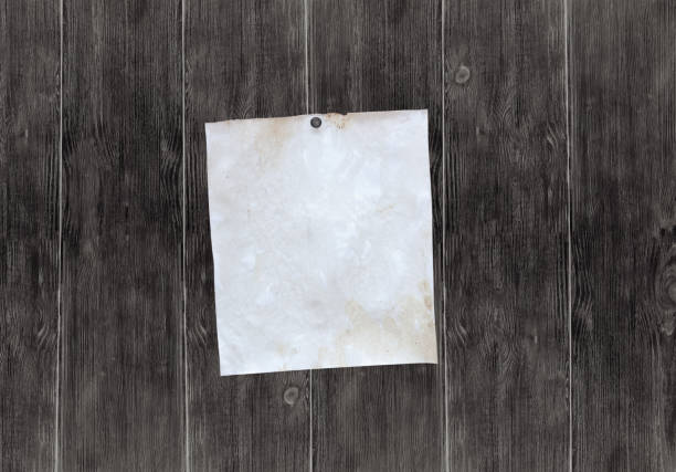 istock Dark wooden old billboard with blank sheet of paper for notes 642441646