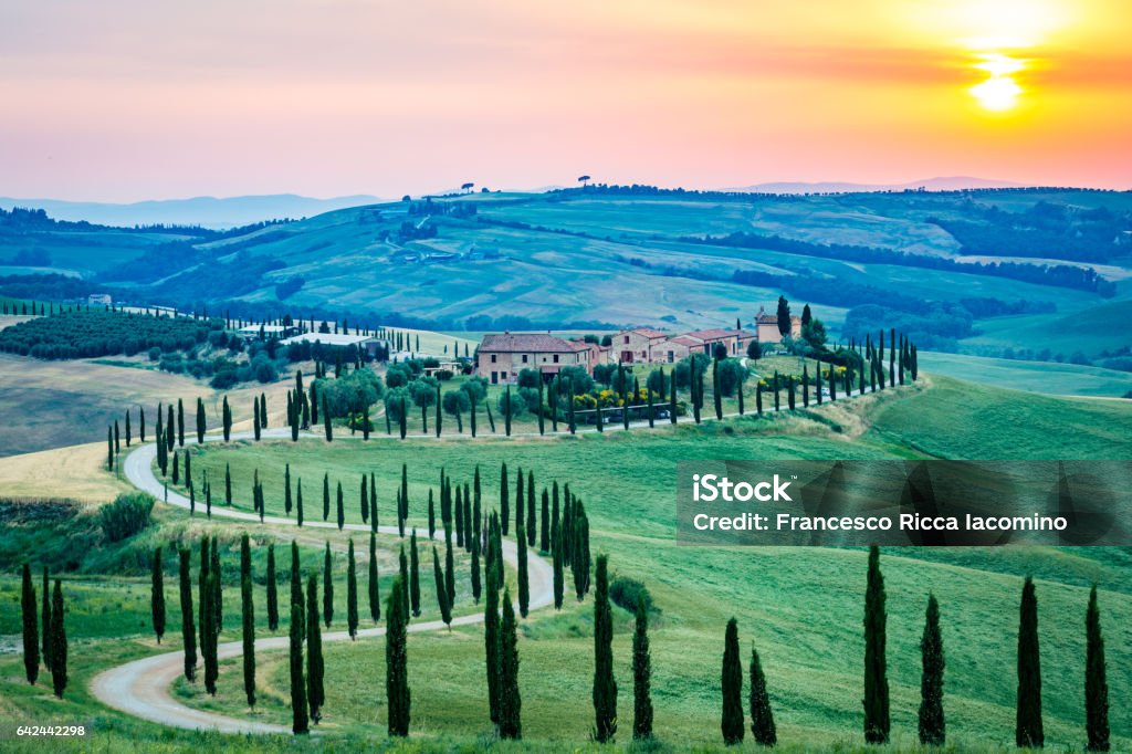 Crete Senesi, Asciano, Tuscany, Italy Crete Senesi, Asciano, Val d'Orcia, Tuscany, Italy. A lonely farmhouse with cypress and olive trees, rolling hills. Val d'Orcia Stock Photo
