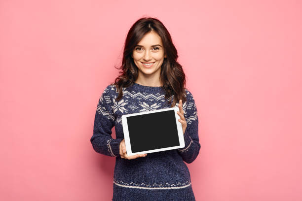 istock Casual young woman showing a black tablet screen 642442526