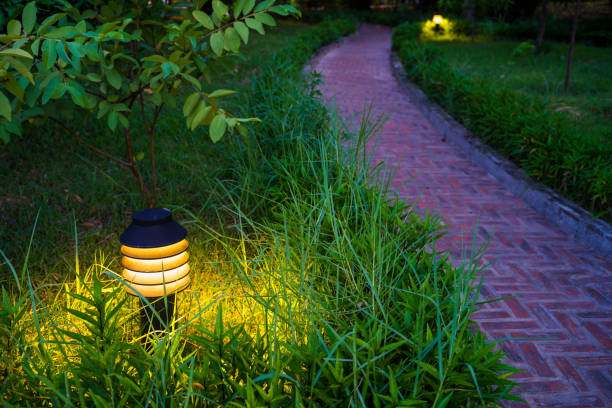 istock Twilight garden scene with lamp and brick curved road 642448236