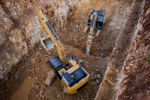 istock Jackhammer excavator and dipper dredger working together in excavation area 642448372