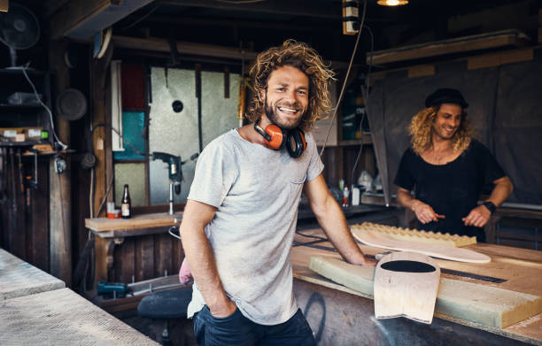 The workshop is our happy place Portrait of two happy young men working on skateboards in their workshop australia photos stock pictures, royalty-free photos & images