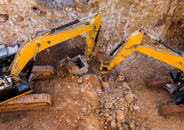 istock Jackhammer excavator and dipper dredger working together in excavation area 642450862