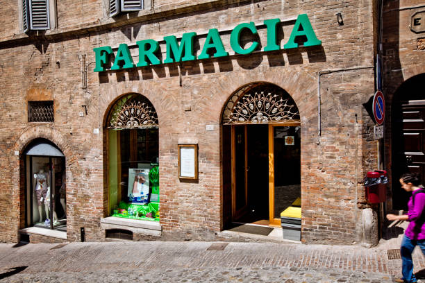 Farmacia sign shop in Urbino city, Italy Urbino, Italy - May, 2011: Farmacia sign shop in Urbino city, Italy farmacia stock pictures, royalty-free photos & images