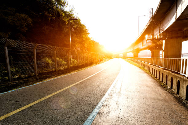 istock city road near river with sunbeam 642454204