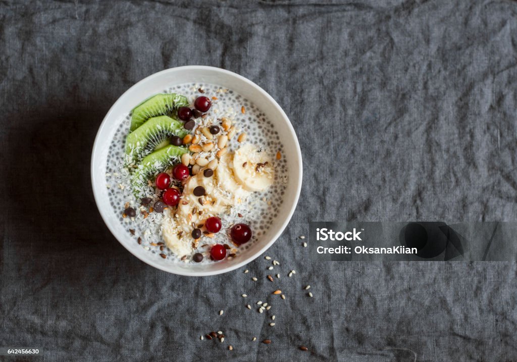 Chia pudding with fruits, seeds and nuts on a dark background, top view. Healthy breakfast or snack Chia seed Stock Photo