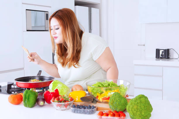 istock Blonde woman cooking vegetables 642456758