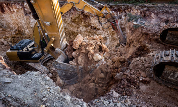 istock Jackhammer excavator and dipper dredger working together in excavation area 642460736