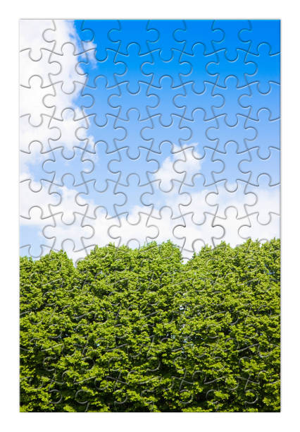 istock Green trees against a cloudy sky - concept image in puzzle shape 642461256