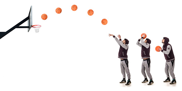 Male basketball player making a basket, shooting a free throw. About 25 years old Caucasian man on white background.