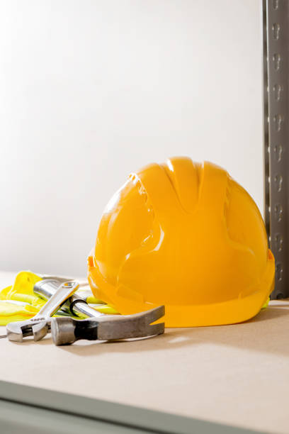 istock Hard Hat, Hammer, Spanner, and Gloves on Steel-Framed Shelf 642464716