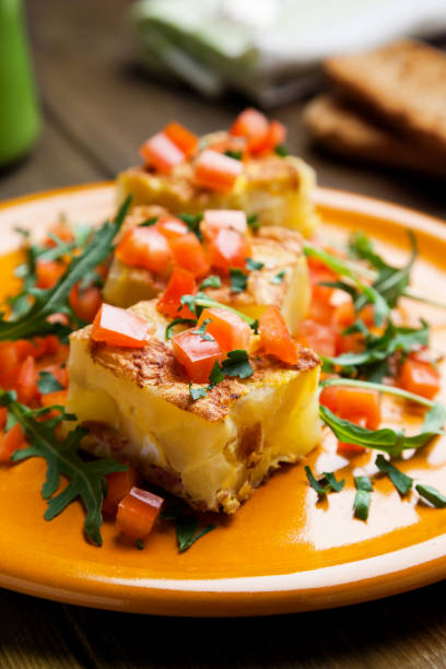 istock Potato tortilla prepared with arugula and tomatoes pieces 642469224