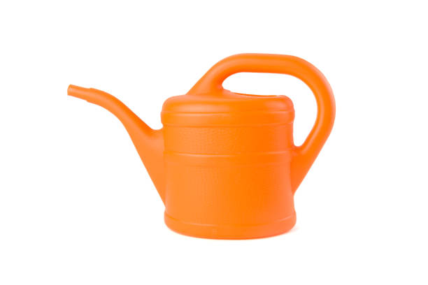 orange watering can on white background - water cannon imagens e fotografias de stock