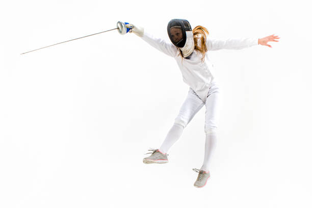 istock Man wearing fencing suit practicing with sword against gray 642476428