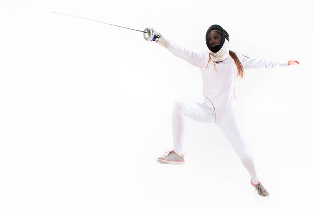 istock Man wearing fencing suit practicing with sword against gray 642476474